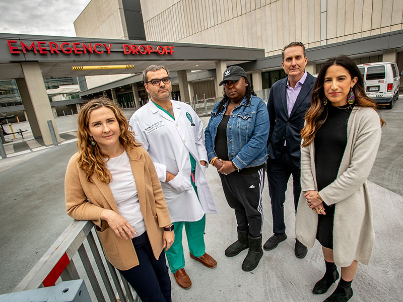 Five partners in the Center for Youth Equity standing in front of a hospital.